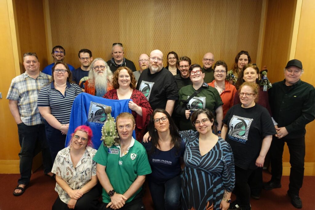 A group of smiling volunteers posting for a photograph